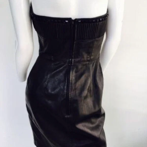 Black leather  strapless dress. 

Features a sweetheart plunge cleavage. - Picture 7 of 11